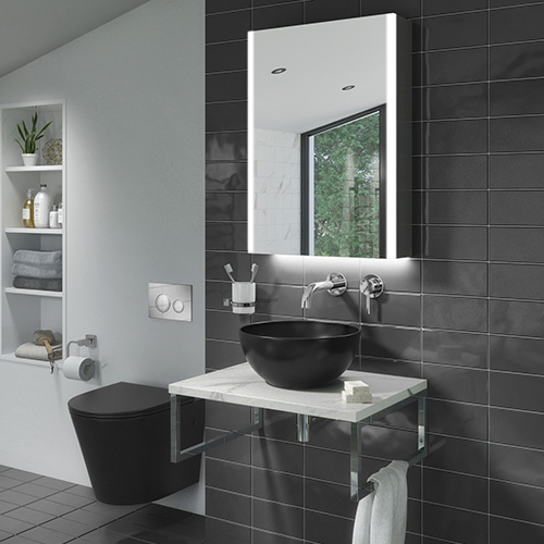 Small bathroom with dark grey tiles, black basin & toilet, plus an above-basin cabinet with illuminated mirror.